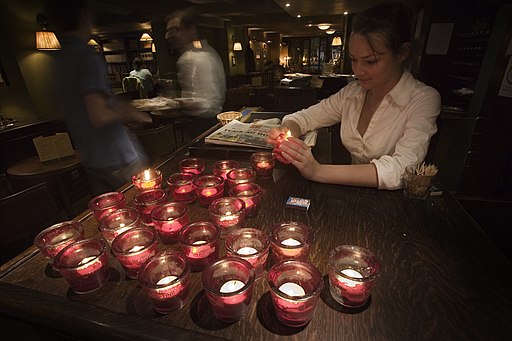 Paris - A waiter lighting candles in a bar - 3418